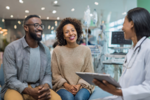 Fertility specialist consulting a Nigerian couple on strategies to improve IVF success rate in a modern clinic.