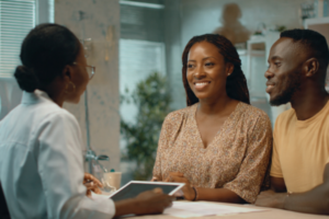 Fertility clinic guide showing a Nigerian doctor consulting a couple about fertility treatment options
